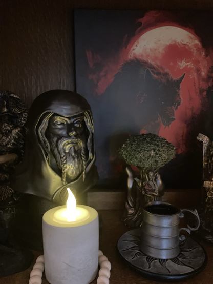 Pagan altar with Odin statuette and wine offering