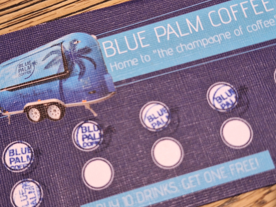 Coffee stamp collection card, in violet and with a blue trailer printed on top. It says Blue Palm Coffee, Home to the "champagne of coffee".
Fuve stamps have been collected.