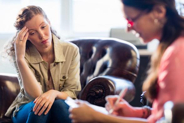 A person with depression at a psychiatry session. Image by wavebreakmedia via Shutterstock.