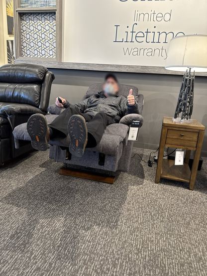 Photograph of person lying back in La-Z-Boy recliner giving a thumbs-up signal, under a banner “limited lifetime warranty”