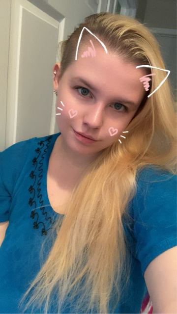 Selfie of Queen in a blue dress with a cat ears snapchat filter 