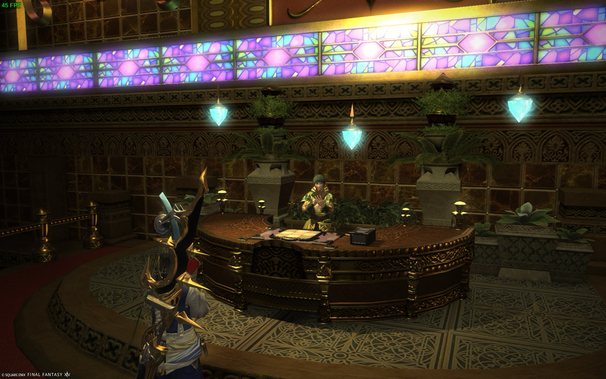 A player character in Final Fantasy XIV stands before a large, ornate wooden desk. Behind the desk, an NPC dressed in green and gold sits, surrounded by potted plants and decorative accents. Stained glass and hanging crystal pendants decorate the walls. The scene evokes a feeling of opulence and fantasy.  