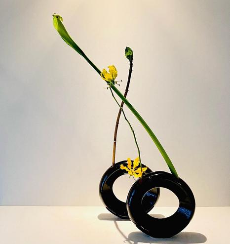 A modern floral arrangement by Mondo Murakami, making use of spectacular circular black vases.