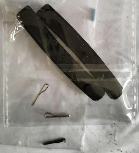Replacement bicycle rim brake pads, including the tiny fixing clips. Next to them is the mangled original brake caliper fixing bolt clip, which is seemingly not available separately, and which was missing from my rear brake.
Buying the brake pads just for the clips is a very simple, cheap, and easy way to get replacement clips for the brake caliper bolts. 