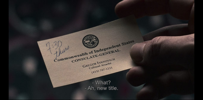 Screenshot from the movie Sneakers (1992), showing Marty holding a business card given to him by Gregor. Gregor's business card reads, "Commonwealth of Independent States", "Consulate-General", "Gregor Ivanovich", "Cultural Attaché", "(415) 707-1221'. At the top-left is written in pen, "7:30 Thurs".  A circular logo of the Commonwealth of Independent States is at top-center.

Subtitles at bottom read "- What?", "- Ah, new title."