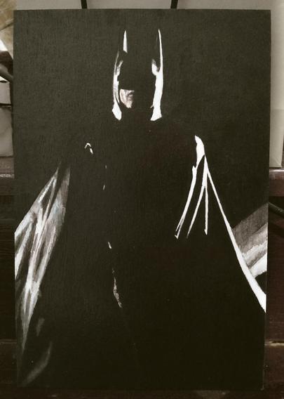 a painting of batman, a black night sky behind him, his silhouette outlined in light, his large cape billowing, he is looking down a the viewer, his eyes obscured with shadows 