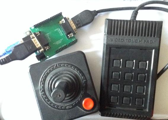 Photo showing an Atari 2600 joystick and "video keypad" both plugged into a custom PCB in Arduino Uno shield form factor.