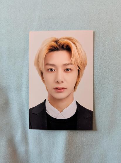 Image shows a wallet sized photo of blonde Hyungwon.