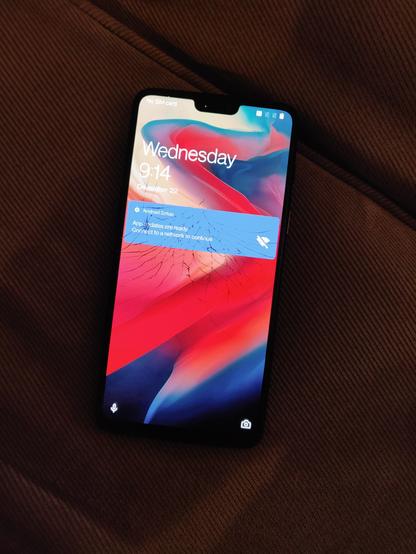 OnePlus 6 with a shattered screen glass, running stock Android.
