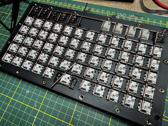 A mechanical keyboard switch matrix using 2mm copper rods instead of wire.