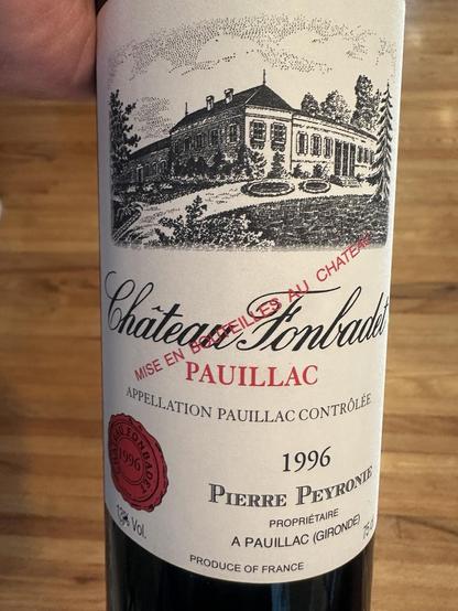 The front of a red wine bottle label Chateau Fonbadet 1996 Pauillac featuring an illustration in black and white of the front of the Chateau

Scanned text: 

“CHATEAU 
Chateaue Tonbab
MISE EN
PAUILLAC
APPELLATION PAUILLAC CONTRÔLÉE
1996ج
BARS
noo vol.
1996
PIERRE PEYRONE
PROPRIÉTAIRE
A PAUILLAC (GIRONDE)
PRODUCE OF FRANCE”