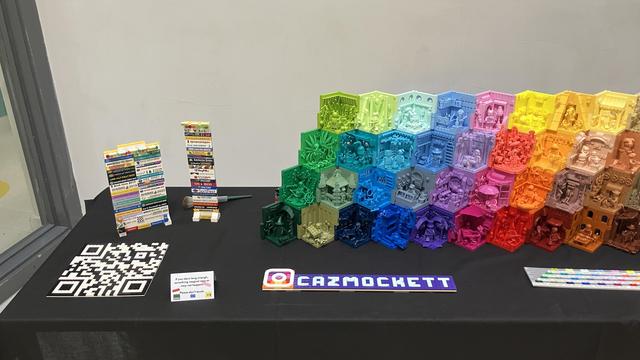 Left side of my display showing a custom brick-build QR code, my stack of show bricks and the left side of my colourful stack of 50 Monochrome Minifigure Habitats
