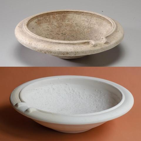 Two white earthenware bowls with a rough surface on the inside.