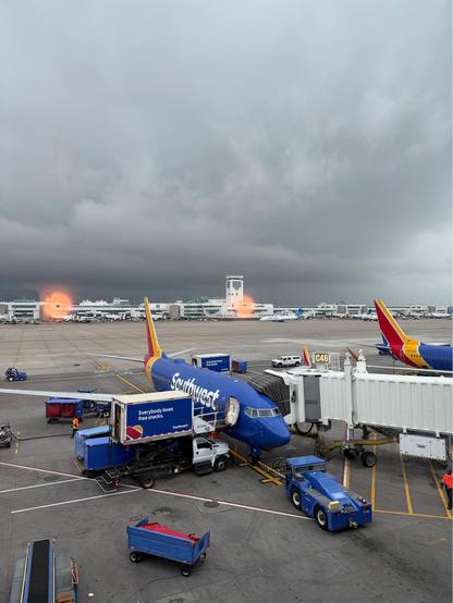 Denver airport looking at dark heavy clouds rolling into the airport. Thunder and rainstorms started right after. 