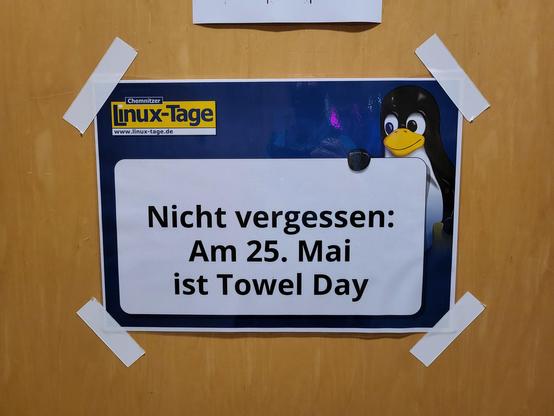 A sign taped to a door, which says: "Don't forget: May 25th is Towel Day"