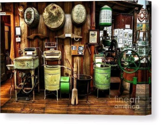

Some old "retro" washing machines, tubs and other equipment used around the middle of the 19th century.
By Kaye Menner Photography.

THE FINE ART AMERICA LOGO WILL NOT SHOW ON PURCHASED PRINTS OR PRODUCTS.

Clothes washer technology developed as a way to reduce the manual labor spent, providing an open basin or sealed container with paddles or fingers to automatically agitate the clothing. The earliest machines were hand-operated and constructed from wood, while later machines made of metal permitted a fire to burn below the washtub, keeping the water warm throughout the day's washing.

The earliest special-purpose washing device was the scrub board, invented in 1797.

By the mid-1850s, steam-driven commercial laundry machinery was on sale in the UK and US. Technological advances in machinery for commercial and institutional washers proceeded faster than domestic washer design for several decades, especially in the UK. In the US there was more emphasis on developing machines for washing at home, though machines for commercial laundry services were widely used in the late 19th and early 20th centuries. The rotary washing machine was patented by Hamilton Smith in 1858. As electricity was not commonly available until at least 1930, some early washing machines were operated by a low-speed single-cylinder hit and miss gasoline engine.

After the items were washed and rinsed, water had to be removed by twisting. To help reduce this labor, the wringer/mangle machine was developed.