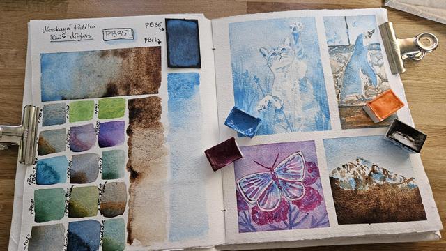 Open sketchbook on a desk. The left side shows many labeled swatches of mixes with the pigment PB35, which is stated on top of the page. There is one swatch on black paper showing how transparent or rather opaque this pigment is and some washes. On the right side are 4 small paintings. One with a playful cat that seems to catch something in just light blue, one with a penguin, where this light blue color is mixed with orange. The mix greate browns and warm greys where the colors meet. Another one shows a purple butterfly, which is the result of the mixes of this light blue and a pink color. The last one is a mountain with blue sky above and dark browns on the bottom of the mountain from the brown that is mixed with the light blue that has been used before as a study.