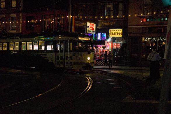 A night photo of the F Market streetcar at the Castro turnaround, captured at high ISO 