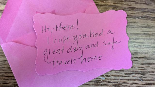 Handwritten note on a slip of pink paper with a matching envelope: "Hi there! I hope you had a great day and safe travels home."

Note was left on a gray Toyota Camry at the Buffalo Grove Metra Station in Buffalo Grove, Illinois, USA.