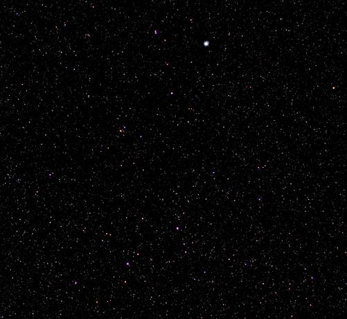 Bright star Vega below middle of top edge. Parallelogram of constellation of Lyra's other bright stars below. Many other stars on a dark background. 