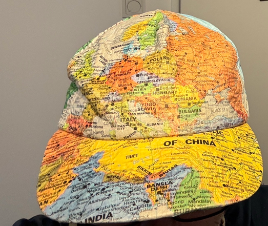 Hat, full covered in a map. Displays Central Europe, USSR, Yugoslavia.