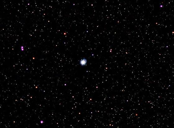 Bright blue star Vega at centre. Many other star dots on a dark background. 