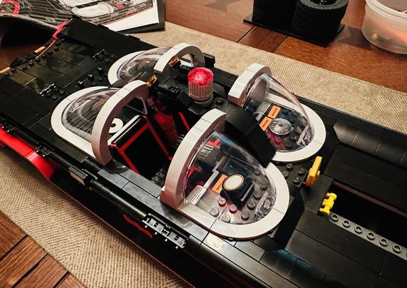 Close up shot of the driver and passenger seats of the LEGO Batmobile build with the special bubble windshields in front and in back of each. 