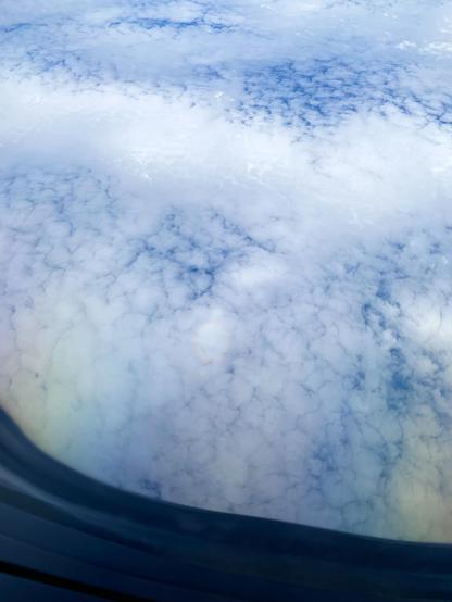 Glory seen from a plane window with widely diffused rainbow colors