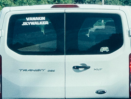 A white Ford Transit has a sticker on the rear window humorously referencing Anakin Skywalker (aka Darth Vader) from Star Wars.
