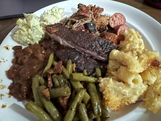 Full plate of barbecue pulled pork, spare ribs, smoked Italian sausage, baked beans, green beans (because I love green beans), Mac and cheese, and cauliflower salad. Don't tell my doctor 😅