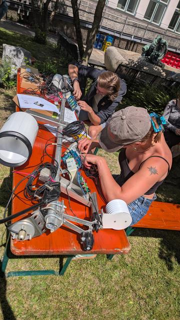 Two students are assembling a meteorological station.