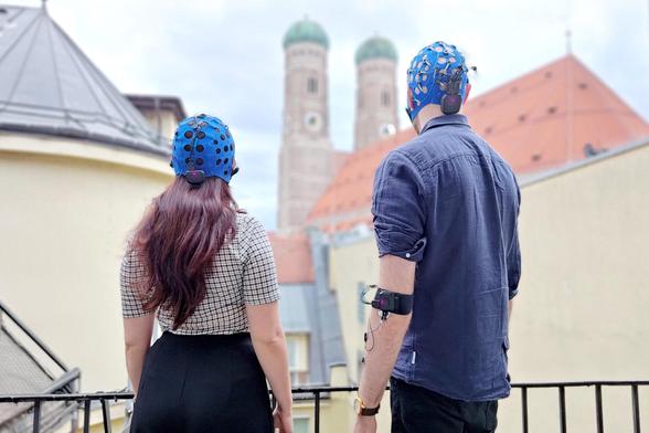 Two people wearing multiple, synchronised Explore Pro EEG amplifiers