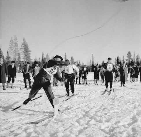 black and white photo of people doing sports in snow