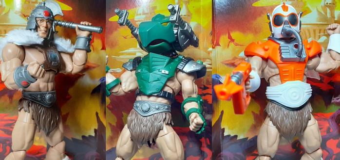 A photo montage of the Vykron action figure in its three different sets of armour. On the left is the barbarian set, complete with fake fur cloak and raised battle axe. In the middle is the tank armour set which is a modern military themed set, green in colour with an over sized tank-like helmet. Finally on the right is the sci-fi themed armour which is a bright orange and white in colour. This has a space helmet and laser blaster which the action figure is pointing straight at the viewer with.