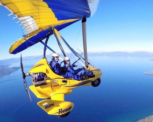 Bright yellow tiny flying machine with para wings for gliding over water 