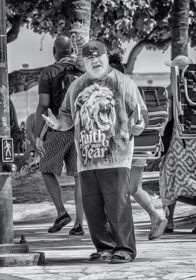 Street preacher preaching (loudly) on Waikiki Beach in Honolulu, Hawaii.