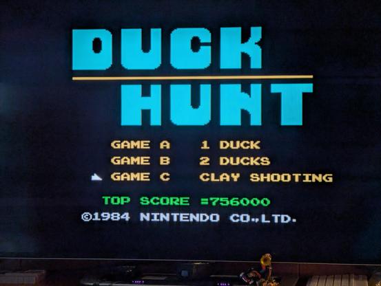 A photograph of a television displaying the start screen for "Duck Hunt," originally for the Nintendo Entertainment System and here played as the official port to the Nintendo Wii U.

The available game modes are Game A - 1 Duck, Game B - 2 Ducks, and Game C - Clay Shooting.  The current top score for Clay Shooting is 756000.
