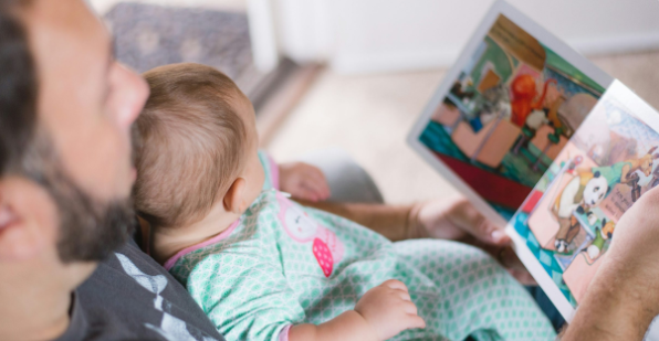 Dad reads to baby