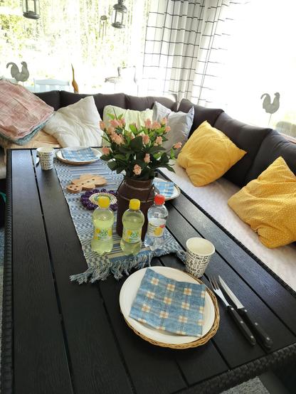 A table and sofas in the summer cottage. The table is served 
