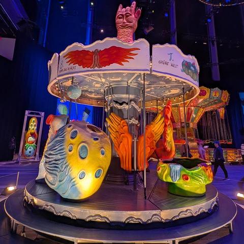 image of a carousel with surreal seats