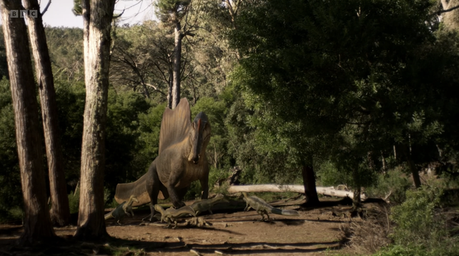 Screenshot from Walking With Dinosaurs (2025) showing a Spinosaurus father looking after his young. Image: BBC/PBS/ZDF/France Télévisions.