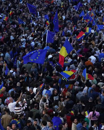 People wave Romanian and EU flags at a pro-EU demonstration, in Bucharest, Romania