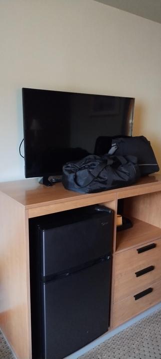 Photo of  two black bags obscuring the (useless) tv screen