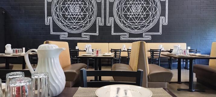 Namaste The Royal Taste Of India, general seating area with some mandala art painted on the wall