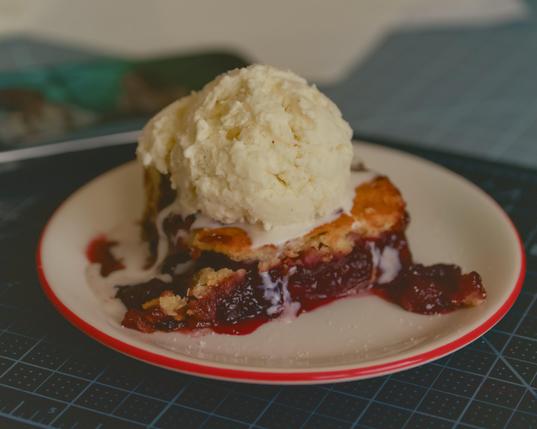 The cherry pie with ice cream on my desk.