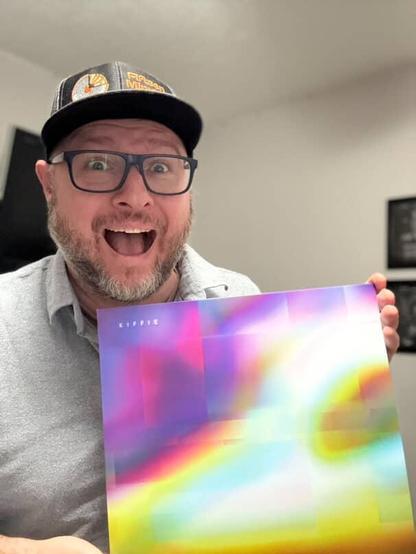 Jeff Thomas smiling and holding his copy of the album Approaching the Horizon on Vinyl.