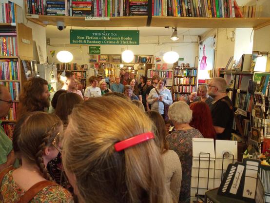 Interior of a bookshop with loads of people in it.