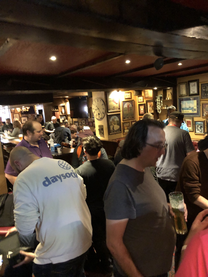 Above shot of various attendees socializing across the bar