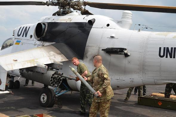 Ukrainian peacekeepers in Africa loading missiles into a helicopter. Ukraine, peacekeeping mission, UN helicopter, Ukrainian soldiers for UN peacekeeping forces
