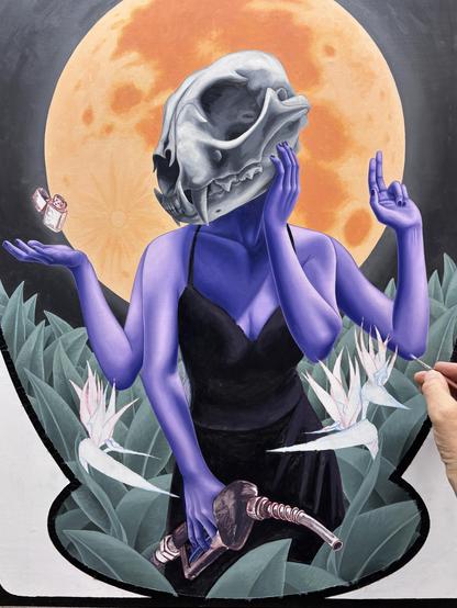 Oil painting in progress of a woman with a lynx skull for a head, with 4 arms. One hand is holding a hose from a gas pump, one hand is on her cheek, one holds up 2 fingers, one is palm up with a zippo lighter floating just above. She is surrounded by plants and bird of paradise flowers.